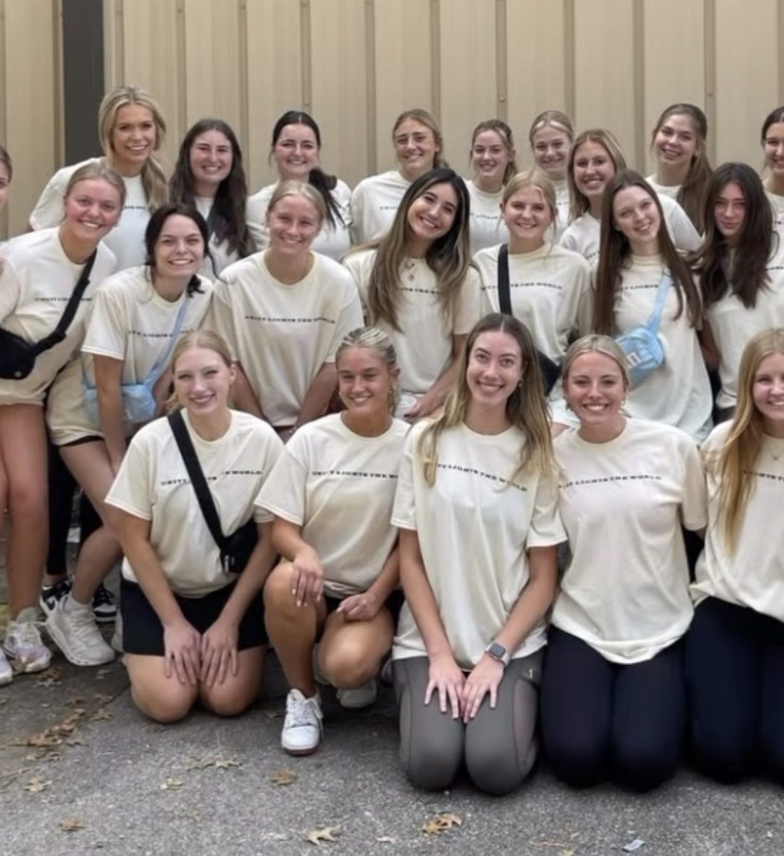 A large group of volunteers in matching shirts